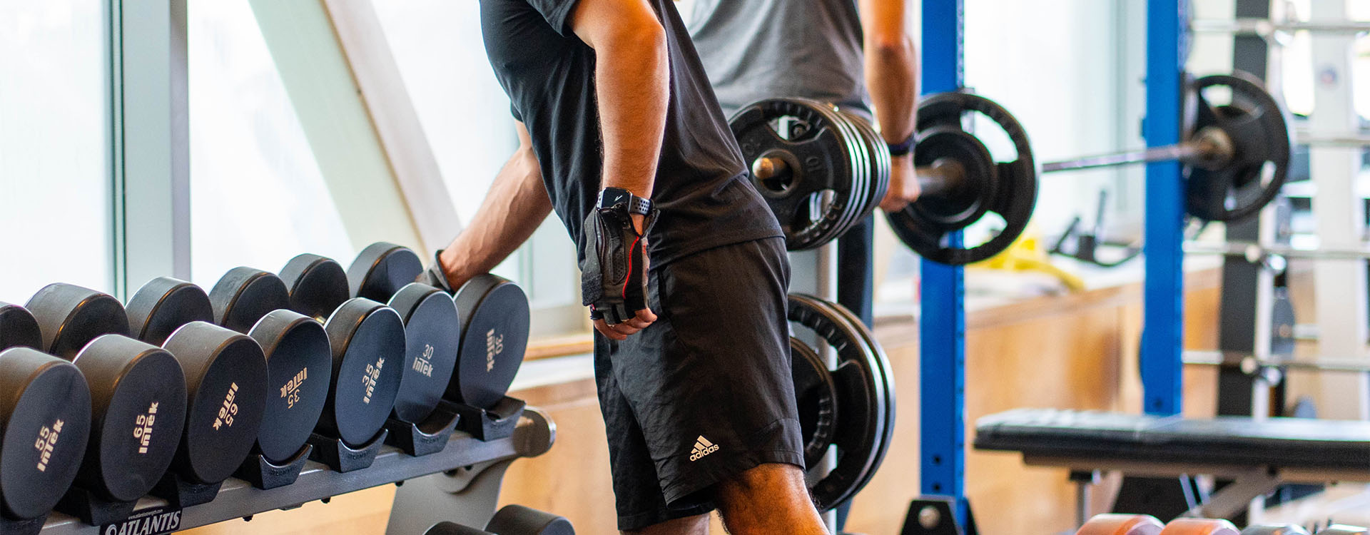Member lifting weights in the Cricket Club Fitness Centre